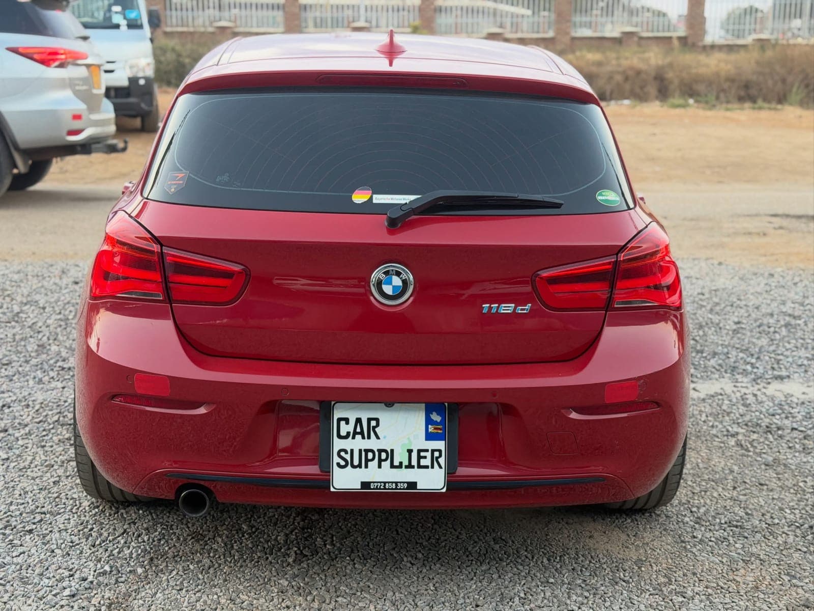 Red BMW F20 118d rear view with 118d badge
