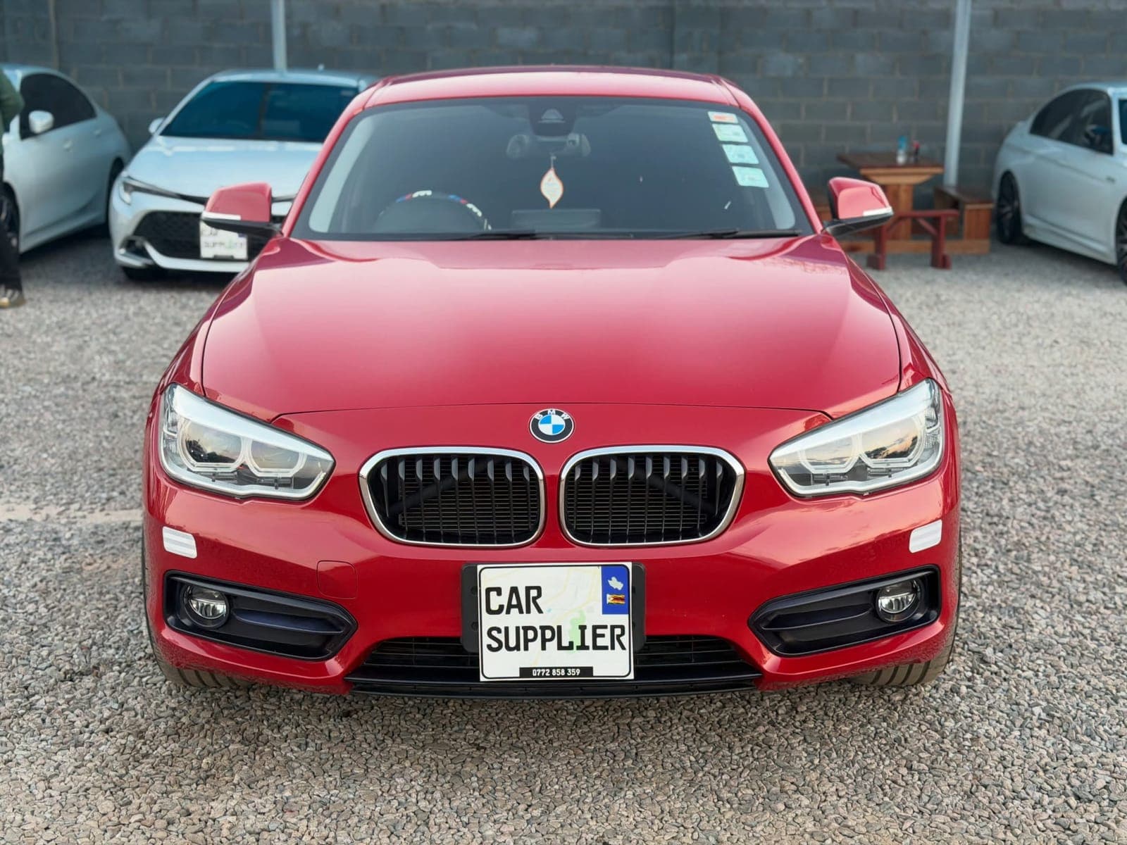 Red BMW F20 118d front view at Car Supplier Zimbabwe